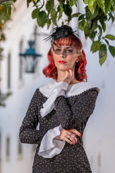 Close up view of a young redhead girl on a retro vintage dress on the urban city.