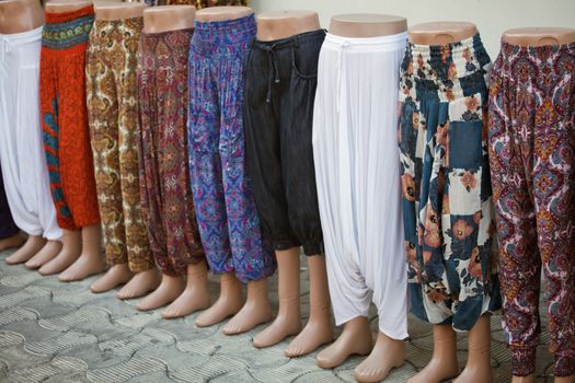 Mannequins wearing pants on a sidewalk of a turkish town