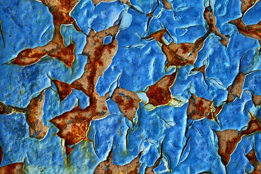 Close-up of peeling paint and rust on a wall