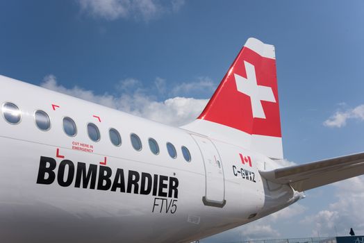 Singapore - February 16, 2016: Rear part of a Bombardier CS100 medium range airliner in Swiss livery during Singapore Airshow at Changi Exhibition Centre in Singapore.