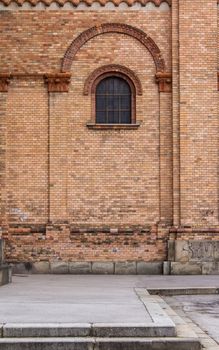 Bricks walls of the Saint Anton Church in Vienna. Window with an arc.