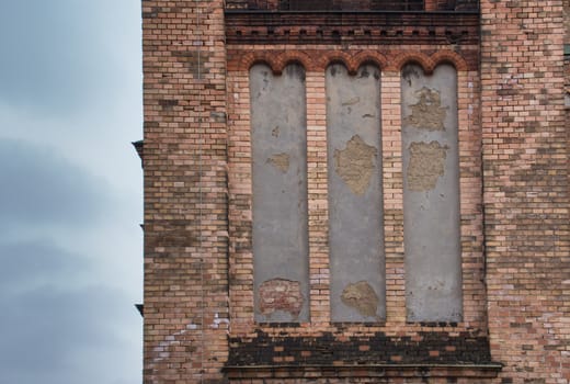 Bricks walls of the Saint Anton Church in Vienna. Cloudy sky.