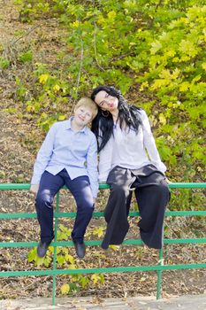 Photo of beautiful brunette and blond boy in autumn