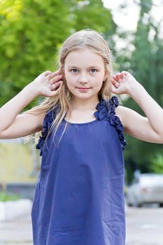 Cute girl with blond hair in summer