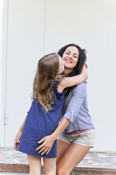 Photo of walking mother and daughter in summer