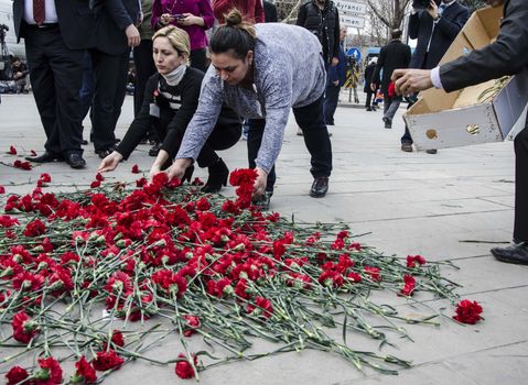 TURKEY, Ankara: People lay flowers at the scene of an explosion in Ankara, Turkey on February 19, 2016, which killed 28 people.