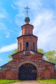 Repairing church of red brick near Yaroslavl in summer sunny day
