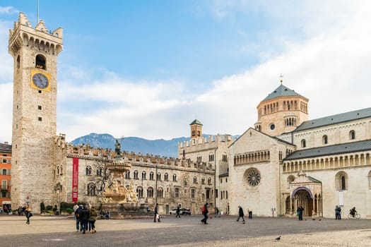 Trento, Italy - December 15, 2015: Dome square with the praetorian palace, city tower and Dome. Trento Cathedral is famous in history because here was held, in the sixteenth century, the Council of the Catholic Counter Reformation.