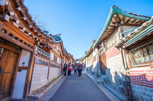 SEOUL,KOREA - MARCH 23: Tourists taking photos of the beautiful scenery around Bukchon Hanok Village,Traditional Korean style architecture, Photo taken March 23,2015 in Seoul, South Korea.