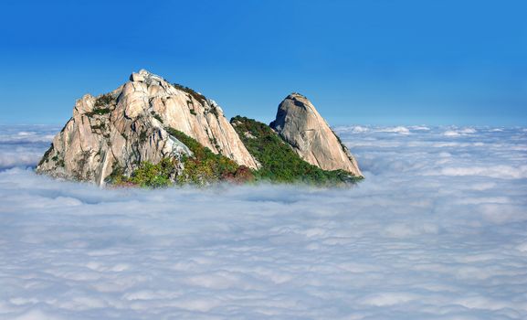 Bukhansan mountains is covered by morning fog in Seoul,Korea