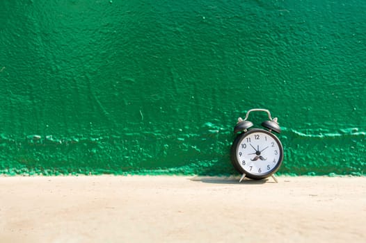 Alarm clock on green background