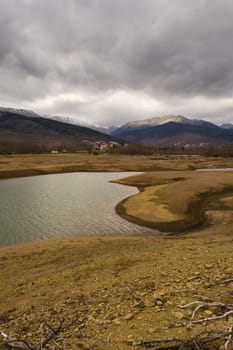 Plastiras lake view with dramatic cloudy sky, in central Greece