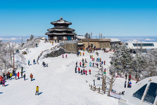 DEOGYUSAN,KOREA - JANUARY 23: Tourists taking photos of the beautiful scenery and skiing around Deogyusan,South Korea on January 23, 2015.