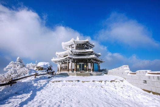 Wooden house is covered by snow in winter, Deogyusan mountains South Korea.