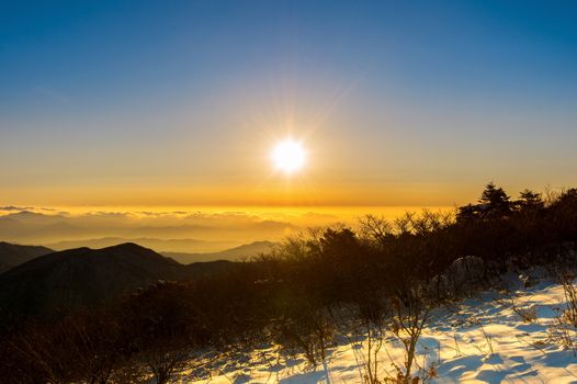 Sunrise with beautiful Lens Flare at Deogyusan mountains in winter,South Korea.