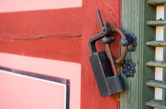 Old rusty lock on the wooden gate