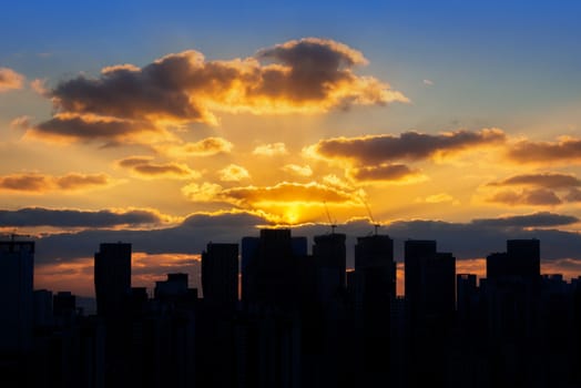 Building's silhouettes of a city and sunset.