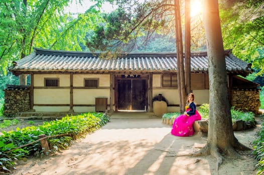 Woman with Hanbok,the traditional Korean dress.Traditional Korean style architecture and sunlight.