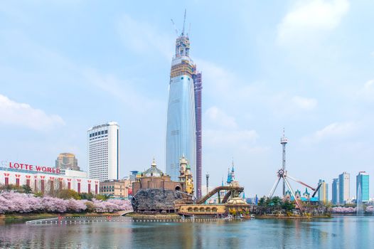 SEOUL, KOREA - APRIL 9, 2015: Lotte World amusement park and cherry blossom of Spring, a major tourist attraction in Seoul, South Korea on April 9, 2015