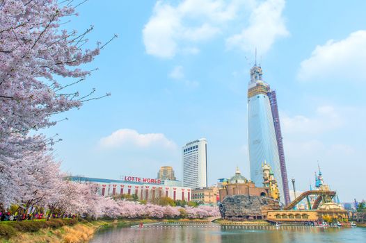 SEOUL, KOREA - APRIL 9, 2015: Lotte World amusement park and cherry blossom of Spring, a major tourist attraction in Seoul, South Korea on April 9, 2015