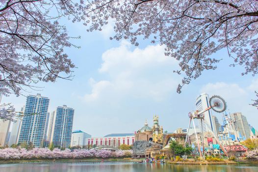 SEOUL, KOREA - APRIL 9, 2015: Lotte World amusement park and cherry blossom of Spring, a major tourist attraction in Seoul, South Korea on April 9, 2015