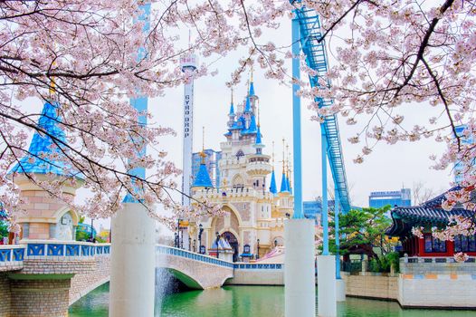 SEOUL, KOREA - APRIL 9, 2015: Lotte World amusement park and cherry blossom of Spring, a major tourist attraction in Seoul, South Korea on April 9, 2015