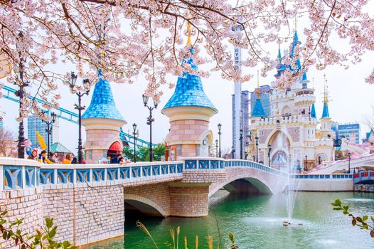 SEOUL, KOREA - APRIL 9, 2015: Lotte World amusement park and cherry blossom of Spring, a major tourist attraction in Seoul, South Korea on April 9, 2015