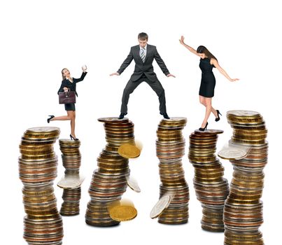 Business people standing on coins isolated on white background