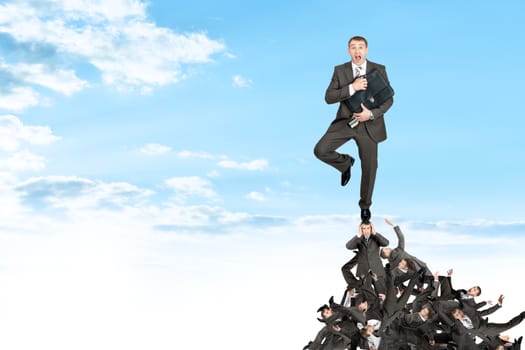 Businessman on pile of people, business concept