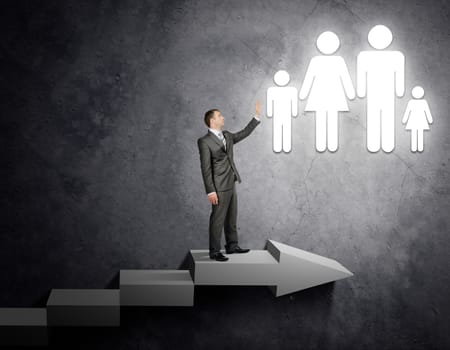 Businessman touching people sign standing on stairs, business concept