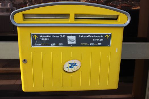 Nice, France - February 15 2016: Yellow Official French Mailbox. A Yellow Modern Postbox From La Poste in Nice, French Riviera