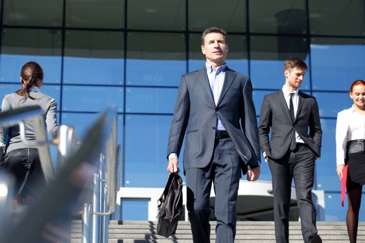 Team of diverse business people at stairs of company office building