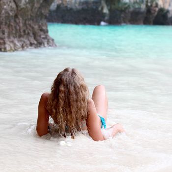 Beautiful woman in thai beach with limestone rocks