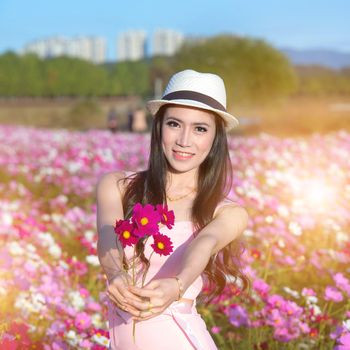 young woman giving bouquet of flowers.