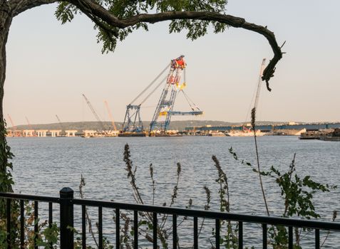 Nyack, New York - September 07 2015: View from Hudson embankment of tremendous crane working on new Tappan Zee bridge.