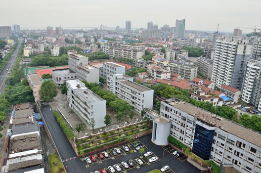 General cityscape of Yueyang city in Hunan province, China. City center with schools, buildings and main street.