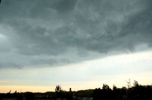 Dark clouds gathering before storm. Clear border between good and bad weather.