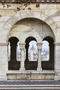 BUDAPEST, HUNGARY - FEBRUARY 02: Hungarian Parliament building seen from between Fisherman's Bastion's arches, at the Old Town district. February 02, 2016 in Budapest.