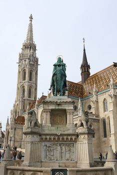 BUDAPEST, HUNGARY - FEBRUARY 02: Bronze statue of Saint Stephen, in the Old Town district, with Saint Saint Matthias church spire in the background. February 02, 2016 in Budapest.