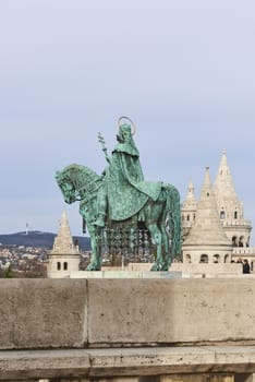 BUDAPEST, HUNGARY - FEBRUARY 02: Bronze statue of Saint Stephen, in the Old Town district, with Fisherman's Bastion spire in the background. February 02, 2016 in Budapest.