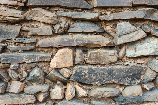 old gray stone wall, background ruins of the ancient city