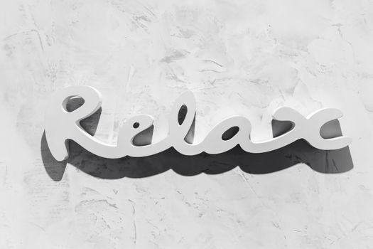 The word "RELAX" written in wooden letterpress type.
