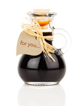 maple syrup in glass bottle or herbal syrup, ardent drink, mixture, with heart label. on white background.