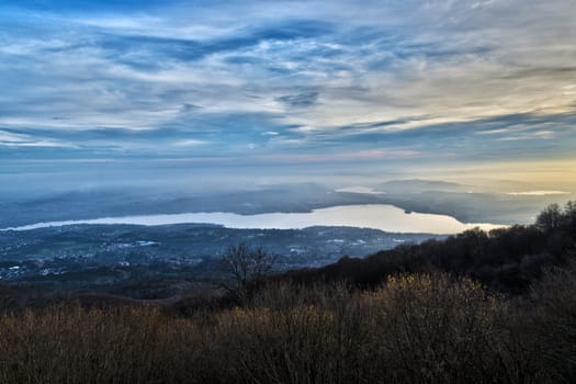 cold and hot lights at the sundown over the Varese Lake in autumn season, Lombardy - Italy