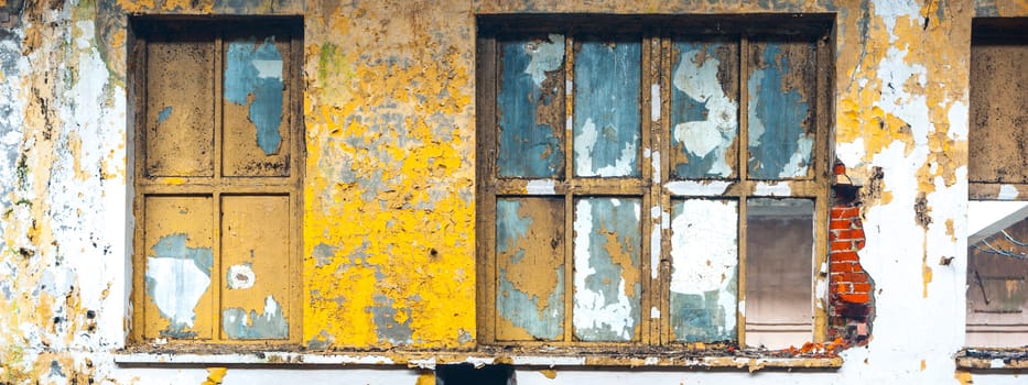 Discarded ruin with old windows and wall, industrial window in concrete wall