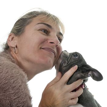 woman kissing bulldog in front of white background