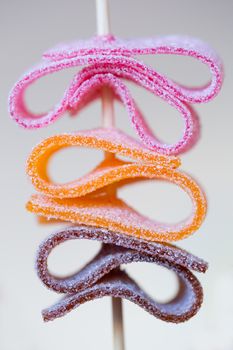 Colorful sugar coated candy skewer with shallow depth of field
