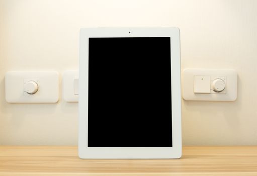 Perfectly detailed modern Tablet placed on a wooden table.