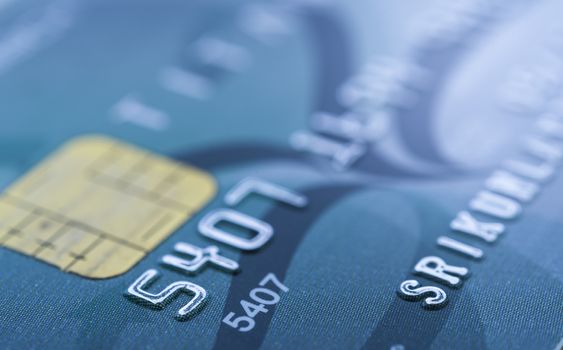 Credit card in blue tone. Selective focus.