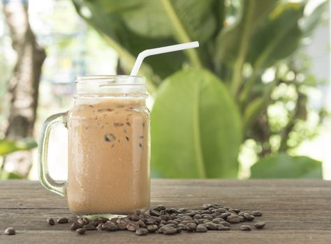 Iced coffee with milk on a wooden table